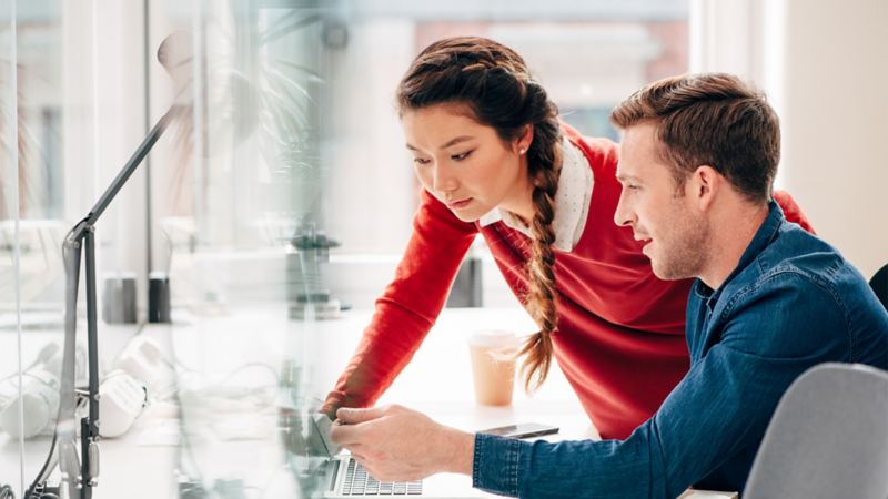 A woman and a man looking at a laptop together