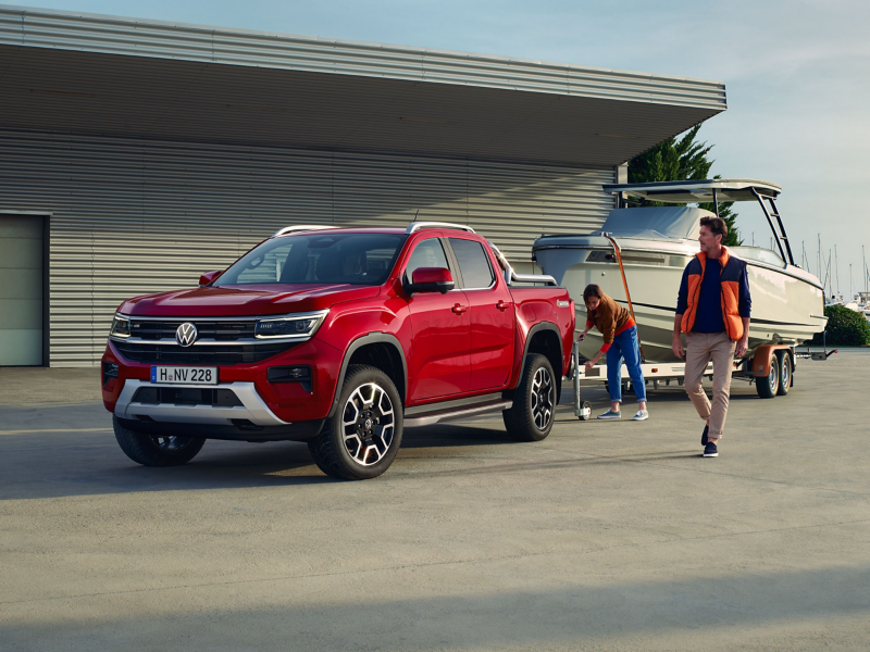 Red Amarok towing a boat 