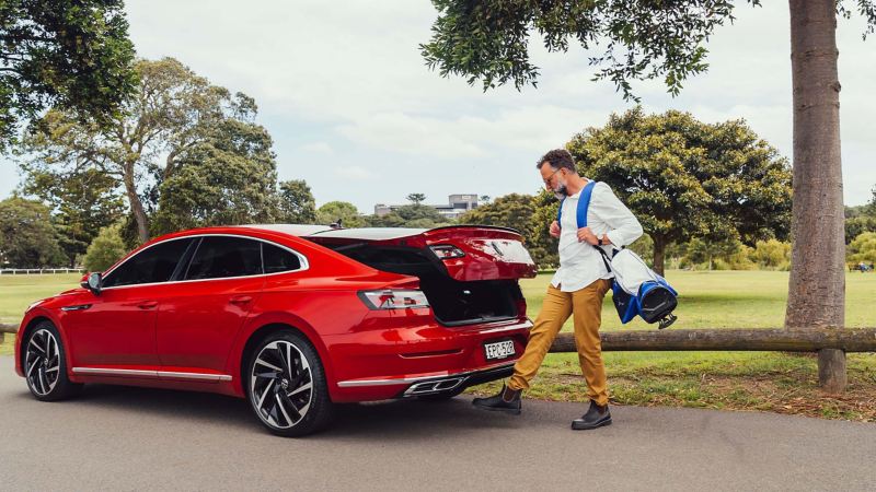 VW Arteon model with man opening the boot