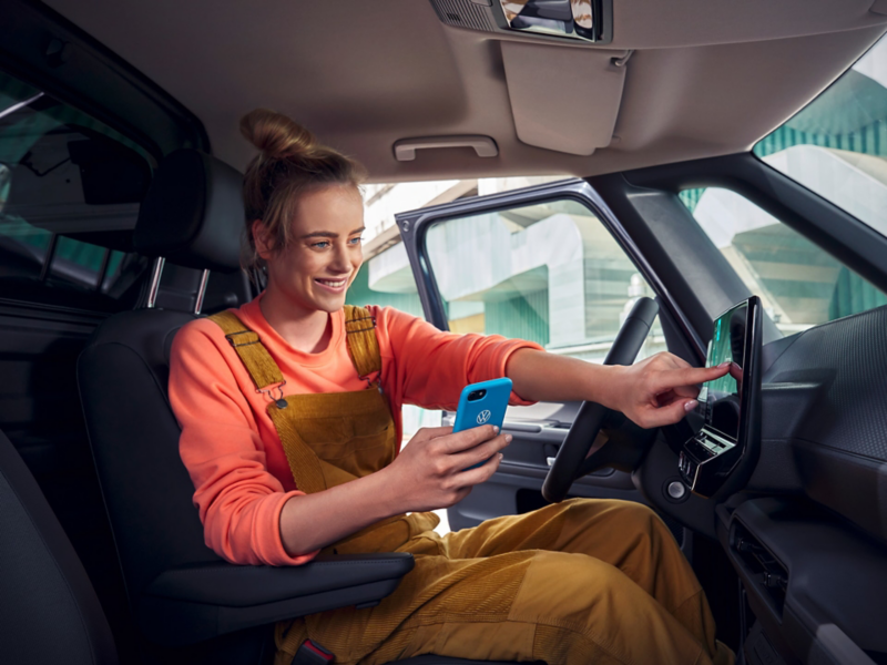 Woman using a phone sat inside the ID. Buzz Cargo cockpit.