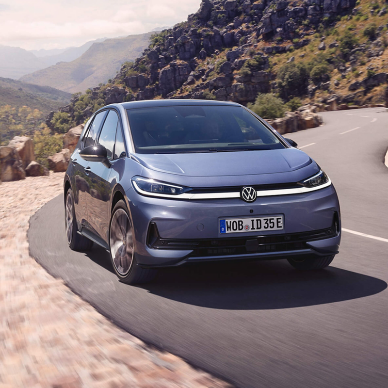 A blue VW ID. Polo being driven on a mountain road