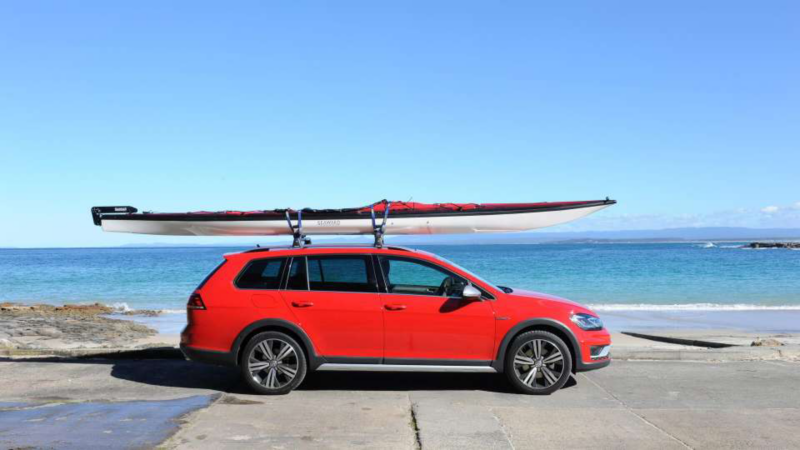 VW car with a boat attached to the roof
