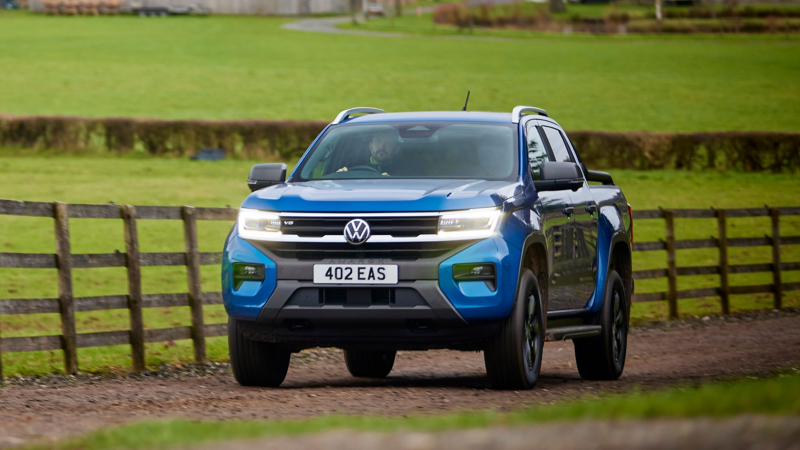 An Amarok driving down a countryside road. 