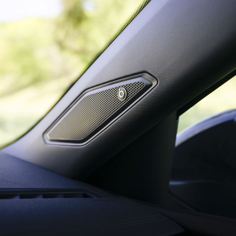 Close-up of the 2025 VW Jetta GLI's interior, showcasing the BeatsAudio® speaker integrated into the car's pillar.