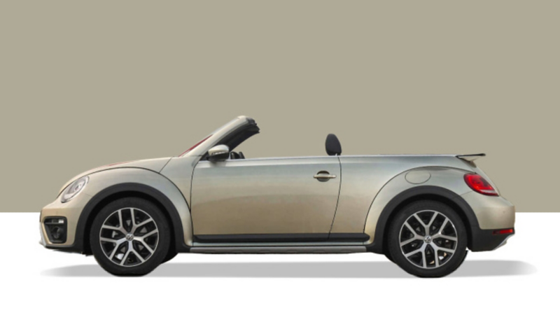 Side view of a VW Beetle on a grey background