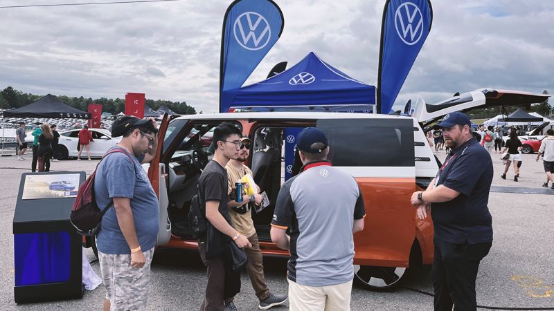 A group of festival attendees checking on the Volkswagen ID. Buzz
