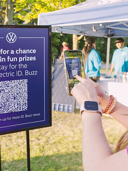 A festival attendee scanning a Volkswagen QR code