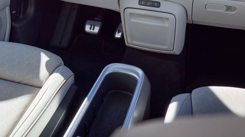 A view of the front passenger seat and center console in the Volkswagen ID. Buzz 2025, highlighting the spacious storage compartment.