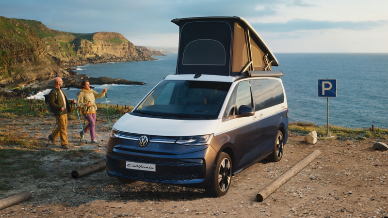 Un California se trouve sur une côte, son toit ouvrant ouvert.