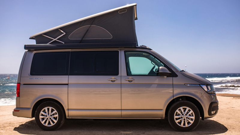 Photo showing a VW California parked at a beach. 