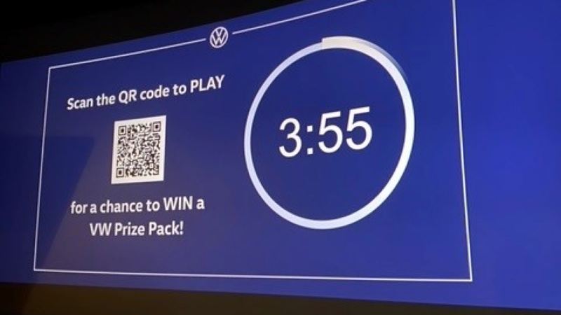 A QR code prompt to play a pre-movie game for a chance to win a prize.