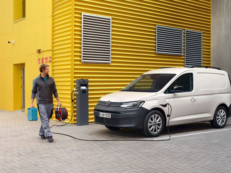 VW Caddy Cargo skåpbil som laddhybrid laddar vid laddstation