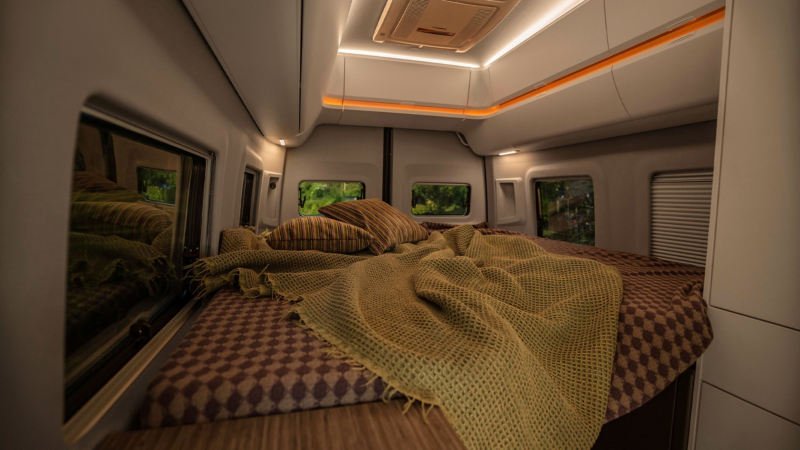 Sleeping area inside Volkswagen Grand California with double bed and ambient lighting