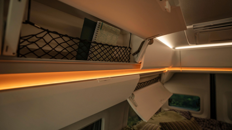 Folding bed showing storage space in VW Grand California motorhome
