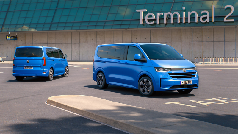 caravelle VW bleue sur un parking d'aéroport terminal