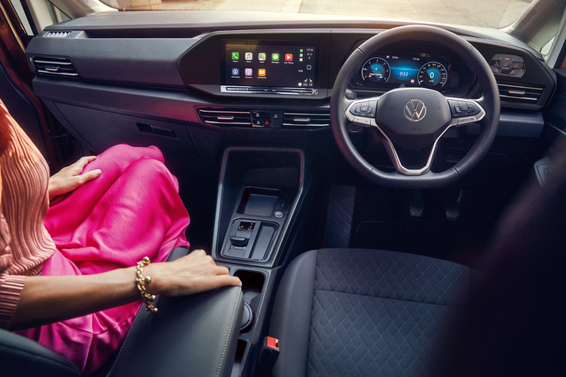 Close up on the steering wheel, Infotainment and Digital cockpit  inside Volkswagen Caddy California.