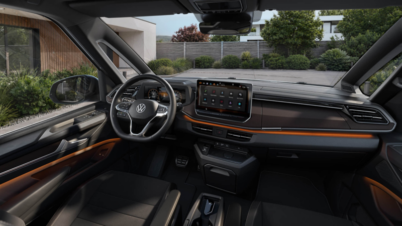 Modern car interior with a sleek design; features include a digital dashboard, large touchscreen display, and leather-wrapped steering wheel.