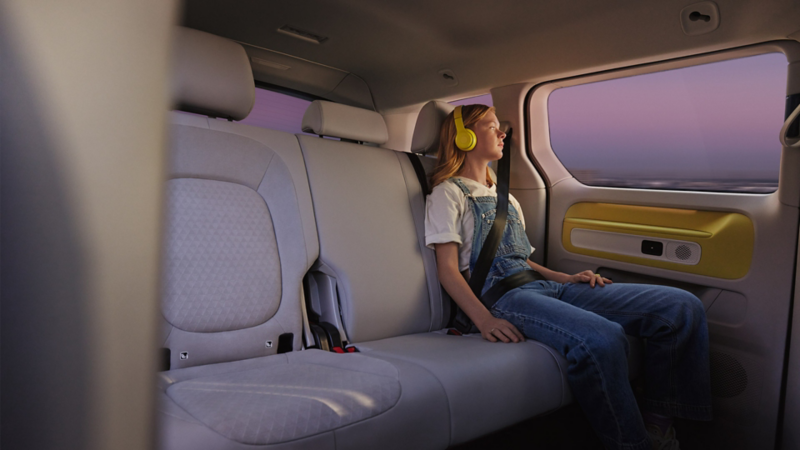 girl listening to headphones in back of id.buzz