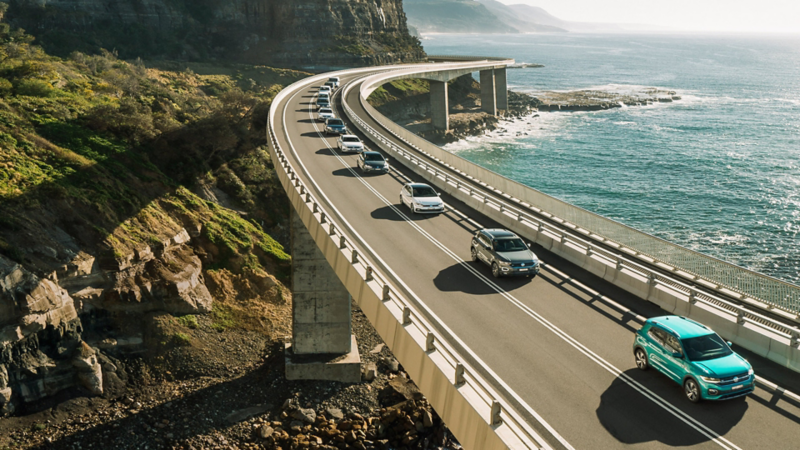 Cars driving along ocean road