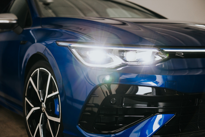 VW Golf R 2024 - headlights at night, car driving on bridge 