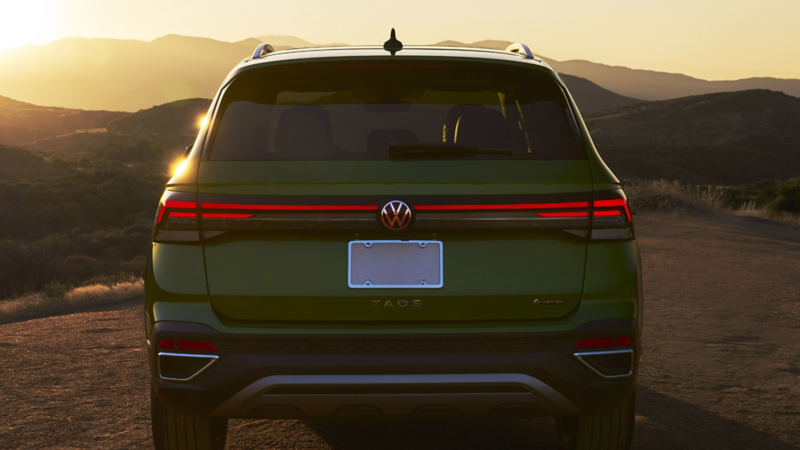 Rear of a green 2025 Volkswagen Taos at sunset