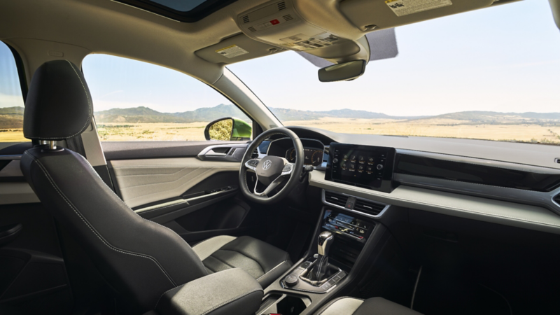 The 2025 Taos interior with a clean, contemporary dashboard, a digital display, and sleek controls.