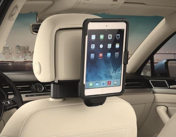 Tablet mounted on the back of a Volkswagen headrest using a communication accessory holder.