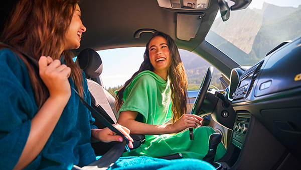 Due donne ridono all'interno di un'auto Volkswagen.