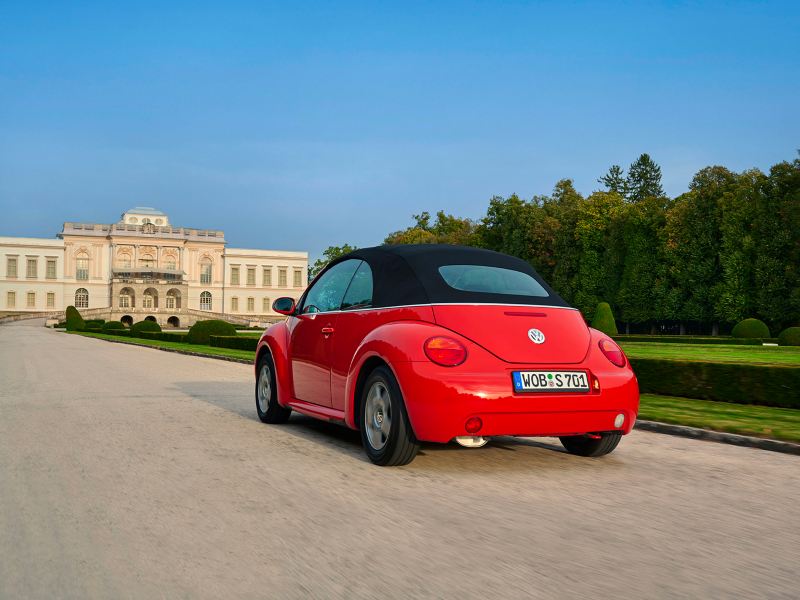 VW New Beetle drives on a road