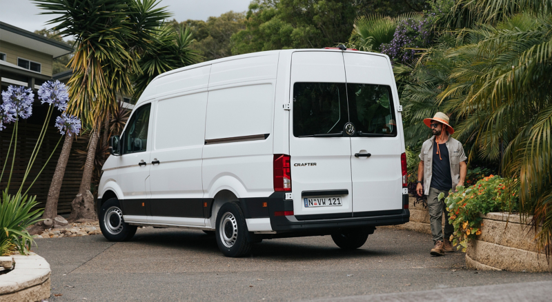 Volkswagen Crafter Van rear side view with man stood next to it