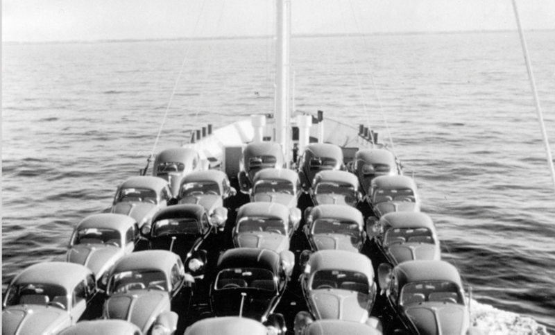 Partcolare della prua di una nave che attraversa l'oceano con VW Beetle parcheggiate sul ponte.