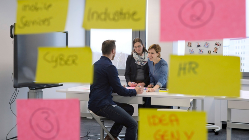 Three colleagues in conversation