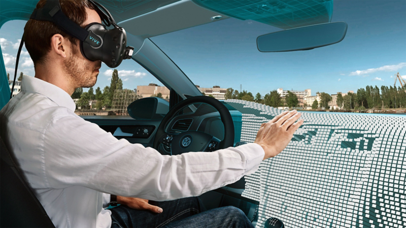 A man wearing VR glasses sitting in a driving simulator 