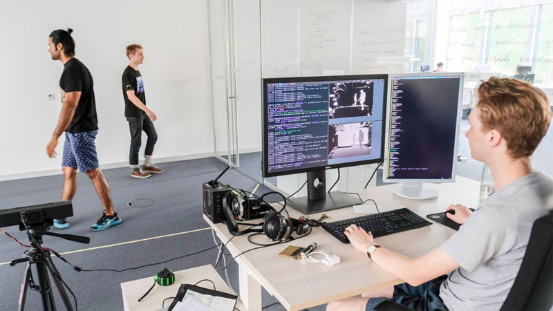 A man at a desk in front of two monitors