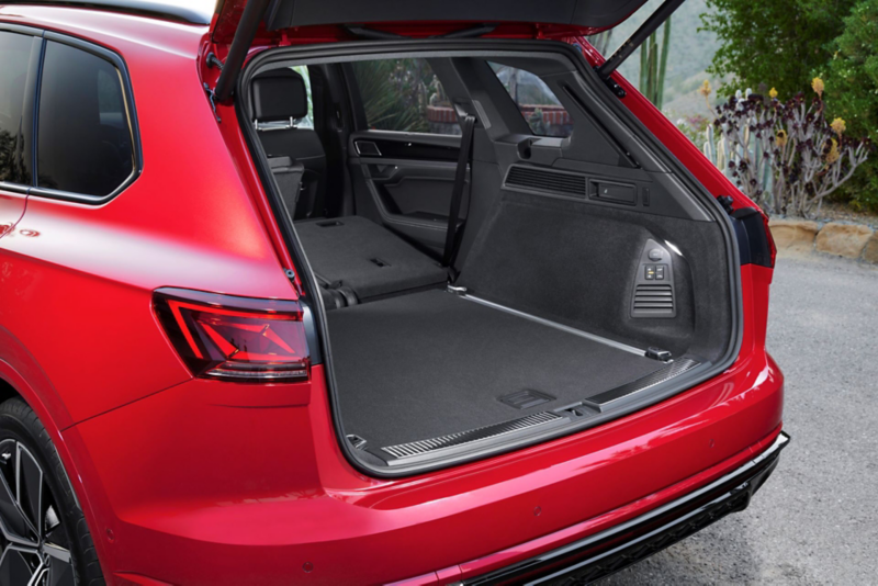 View of the rear of the VW Touareg R-Line with LED tail light clusters, light strip and illuminated VW logo.