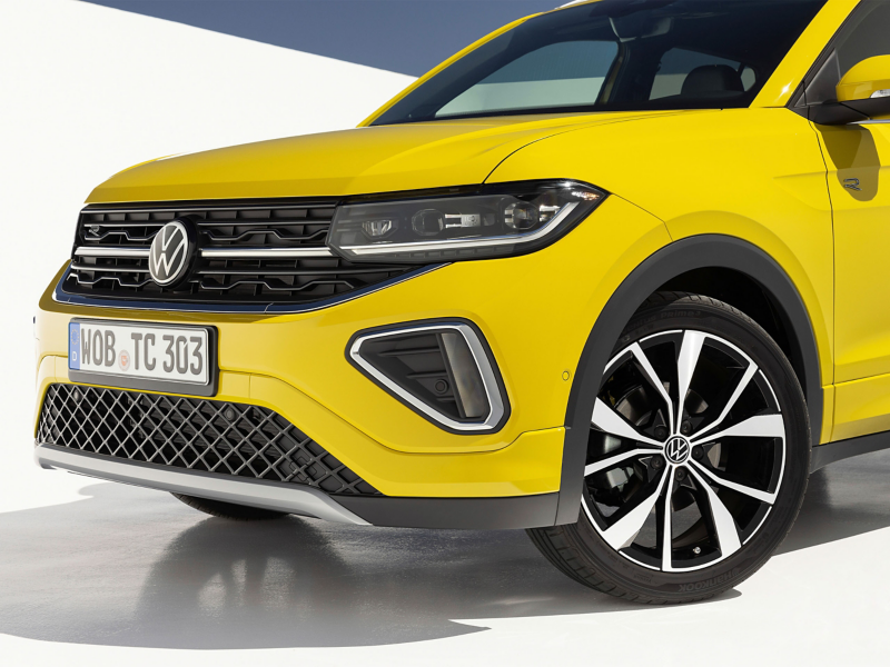 Bold yellow Volkswagen T-Cross in clean white studio background—sleek, modern, and ready to stand out.