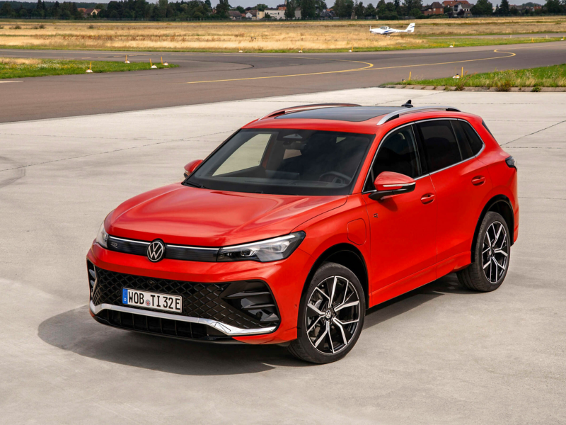 A red Volkswagen Tiguan SUV parked on a runway.