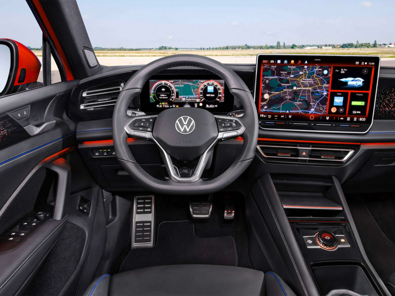 Close-up view of the Volkswagen Tiguan's dashboard and interior. The steering wheel, infotainment system, showcasing the vehicle's advanced technology and premium features.