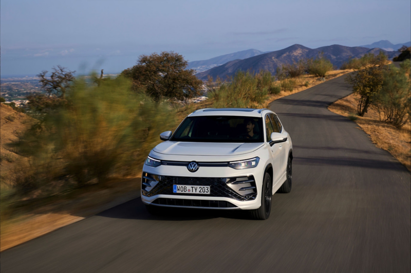 Front shot of Tayron driving on road through mountains