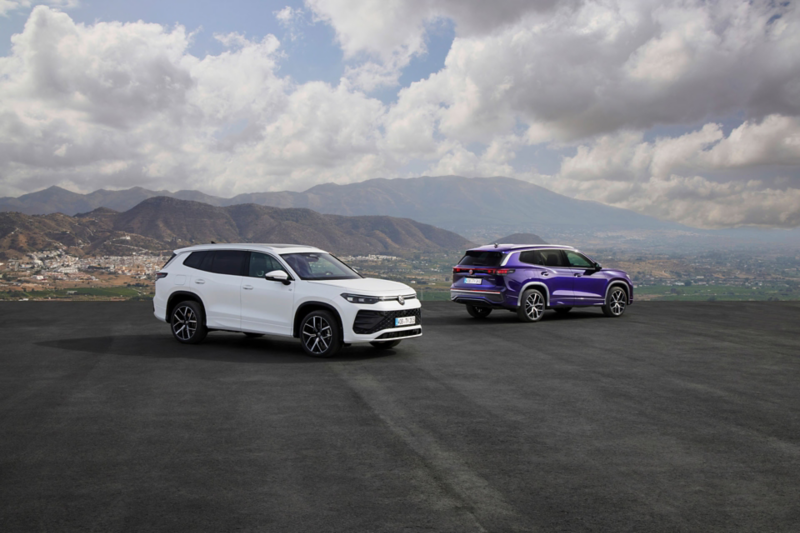 White & Purple Tayrons parked by eachother with mountains in background