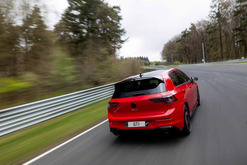 View of the rear of a red VW Golf GTI EDITION 50 in a factory hall.