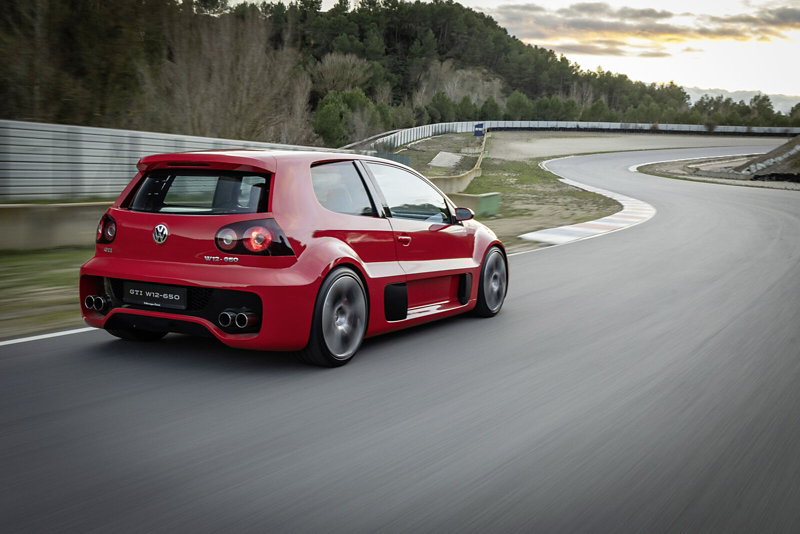 back of a red Golf GTI concept car driving along a winding road