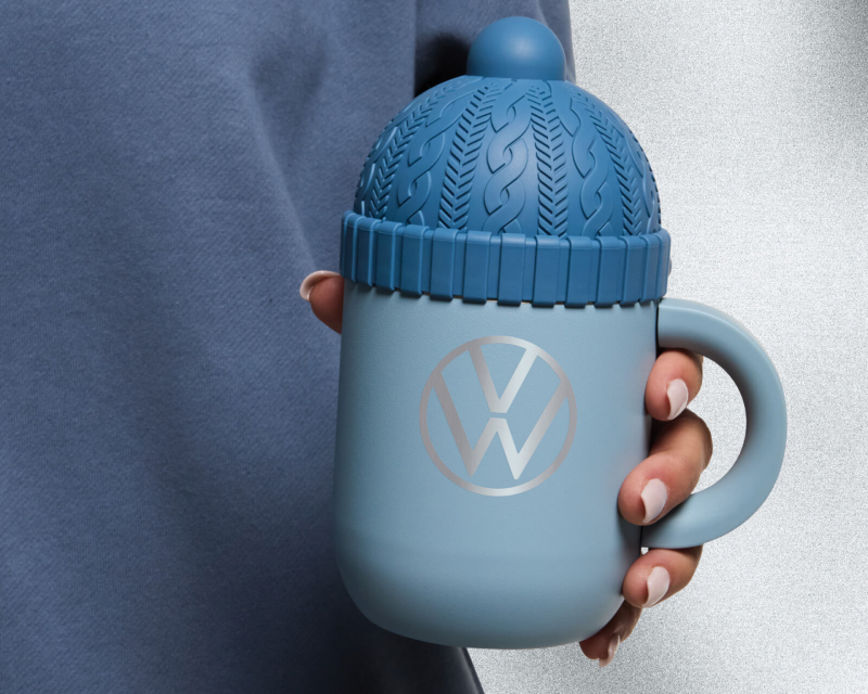 A blue mug with a wool hat-shaped lid.