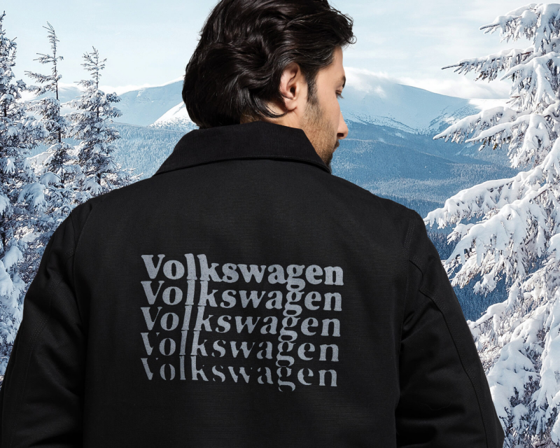 A man from behind wearing a printed jacket.