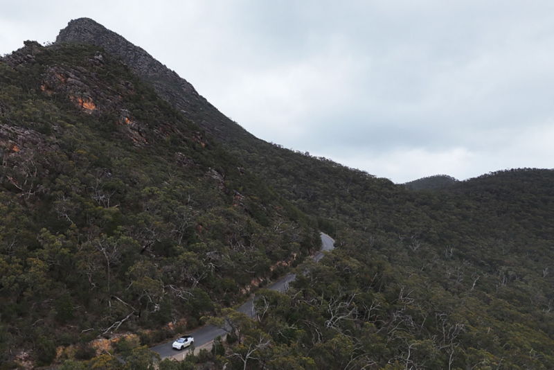 ID.4 driving through winding mountainous forest road