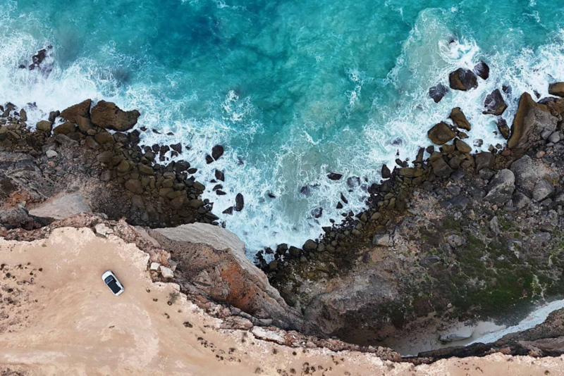 Shot of ID.4 parked at cliff edge with ocean next to it