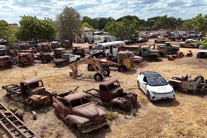 ID.4 parked in yard with old car models