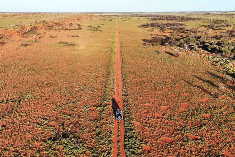Ariel view of Amarok driving through flat desert dirt track