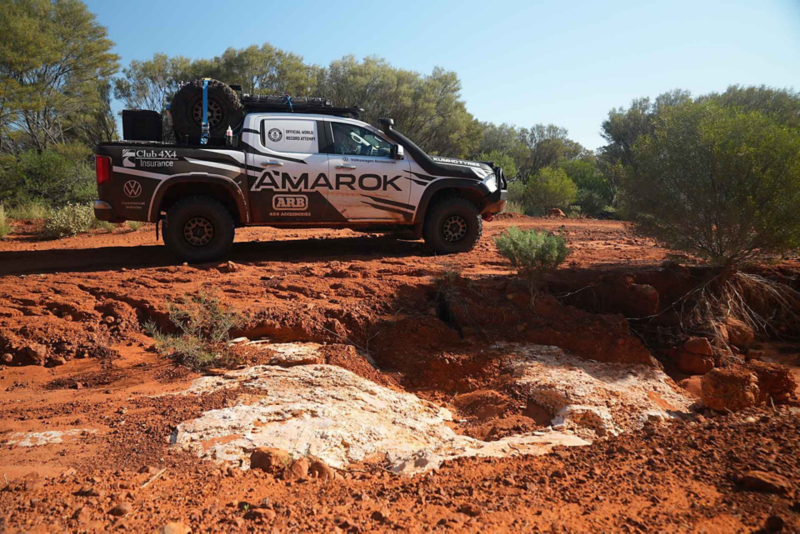Rocky desert terrain with Amarok side view in background