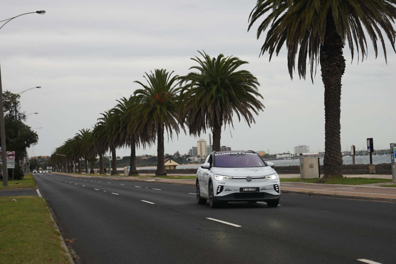 ID.4 driving on road with palm trees